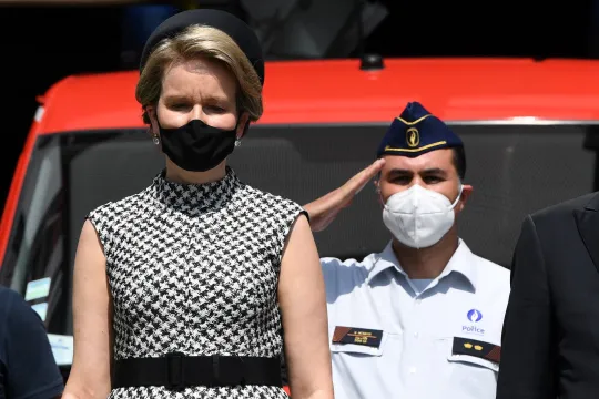 Filip of Belgium (R) and Queen Mathilde of Belgium (2nd L) respect a minute of silence during a tribute ceremony , part of the national mourning day for victims of the severe floods, in Verviers, on July 20, 2021. Belgium's King Philippe and Queen Mathilde paid their respects at the fire station in Verviers, one of the hardest-hit towns. The clean-up is still under way to help the regions hit hardest recover from the scenes of destruction that saw dozens of homes collapsed and cars piled on top of each othe