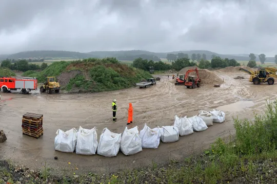 This handout photo taken and released by the German Federal Agency for Technical Relief THW (Technisches Hilfswerk) on July 15, 2021 shows a general view of THW members filling sandbags to protect against flooding following heavy rains and floods in the district of Kitzingen, Germany. Heavy rains and floods lashing western Europe have killed at least 45 people in Germany and left many more missing, as rising waters led several houses to collapse on July 15, 2021. 