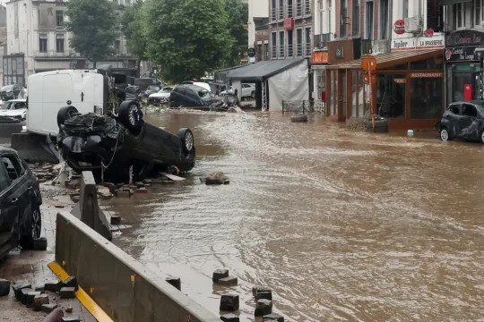 A picture taken on July 15, 2021 shows damaged cars on a flooded street in the Belgian city of Verviers, after heavy rains and floods lashed western Europe, killing at least two people in Belgium. 