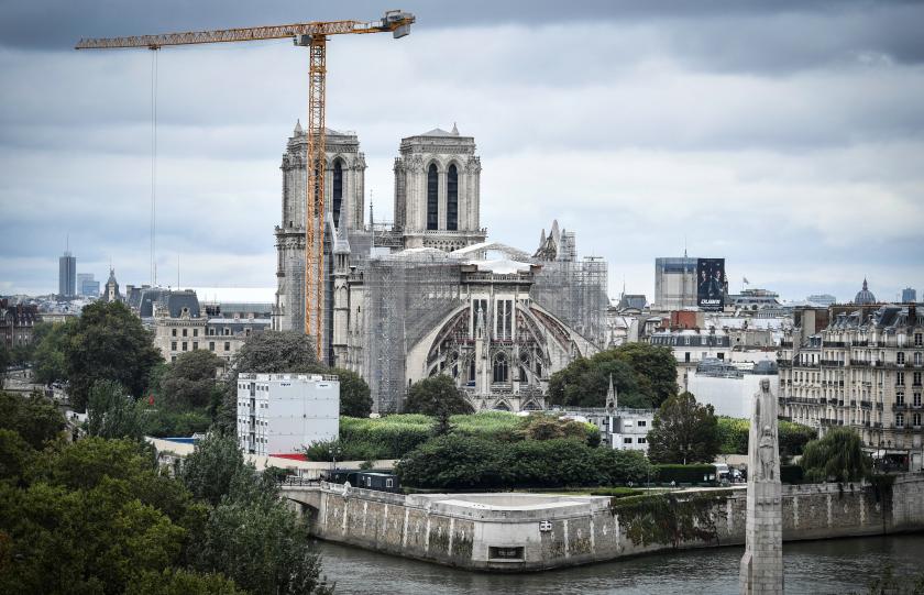 This photograph taken on August 19, 2021 in Paris, shows a giant crane outside Notre-Dame Cathedral, which was partially destroyed when fire broke out beneath the roof on April 15, 2019. 