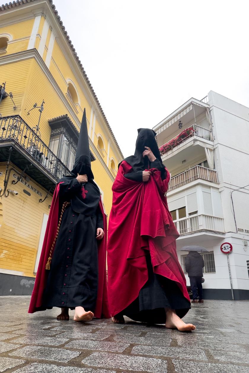 Penitents of the Brotherhood of The Sorrowful Carmen walk barefoot as they head to the procession of Holy Wednesday during the Holy Week in Seville, Spain, 27 March 2024. EPA/David Arjona