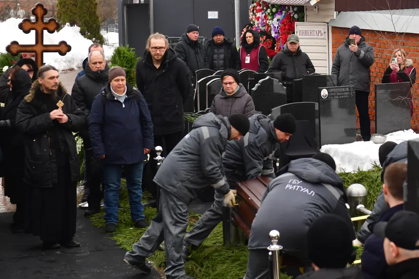 Cemetery workers lower the coffin of late Russian opposition leader Alexei Navalny during a funeral ceremony at the Borisovo cemetery in Moscow's district of Maryino on March 1, 2024. Olga MALTSEVA / AFP